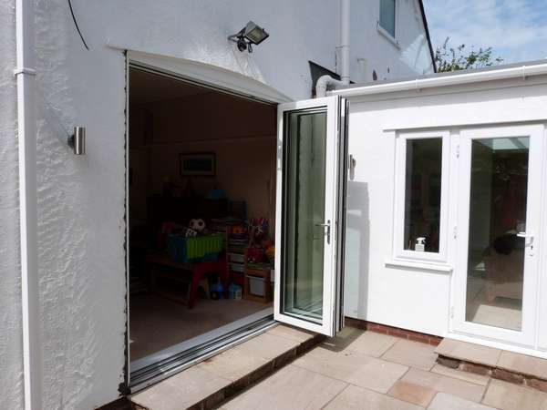 DAVENHAM , CHESHIRE : New Hybrid PvcU /Alumnium Bi Folding doors. Double glazed with 28mm